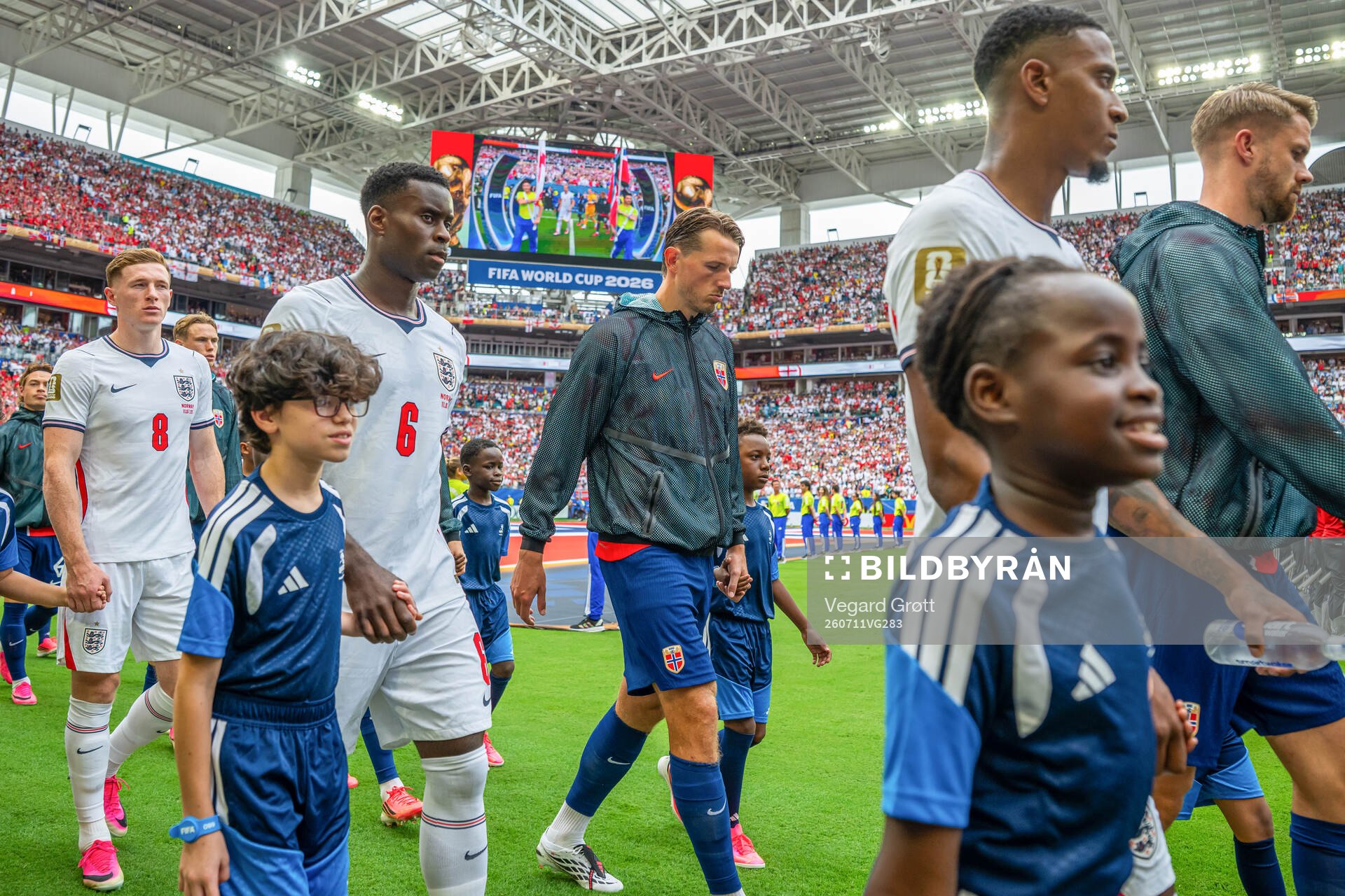 Marc Guehi of England and Sander Berge of Norway enter the