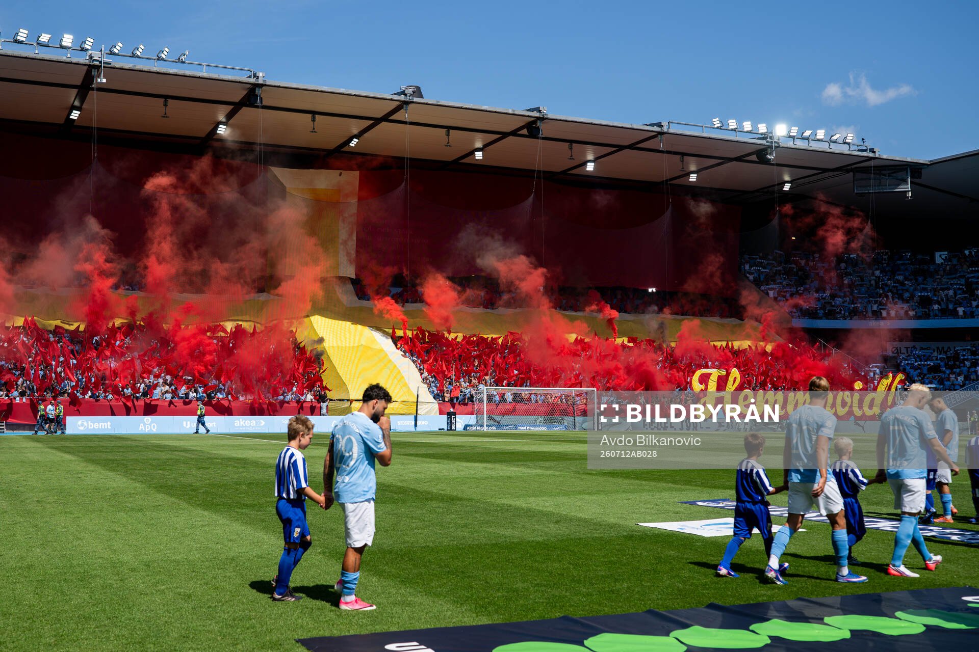 Malmö FFs spelare går in med supportrarnas tifo i