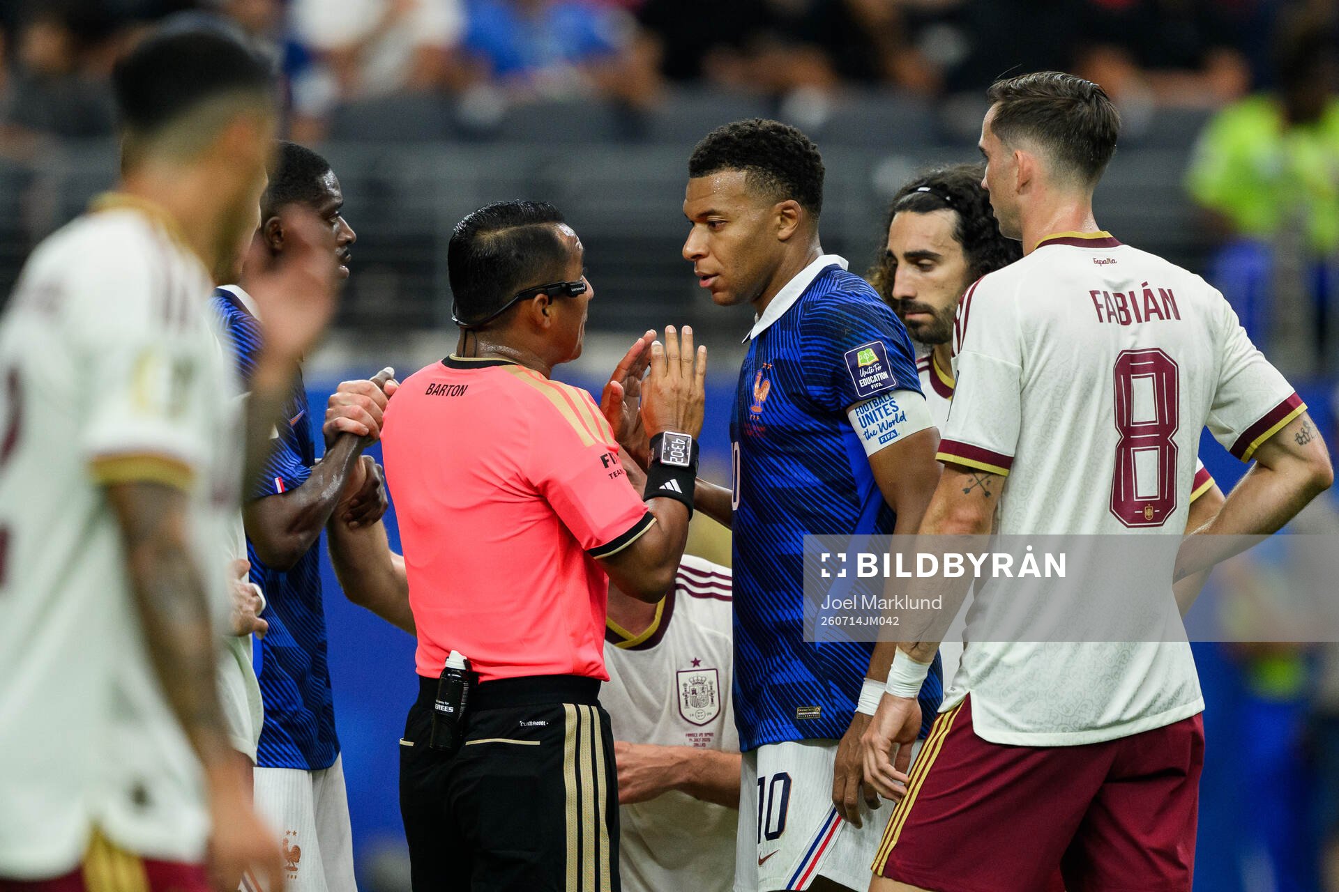 Referee Ivan Barton and Kylian Mbappe of France