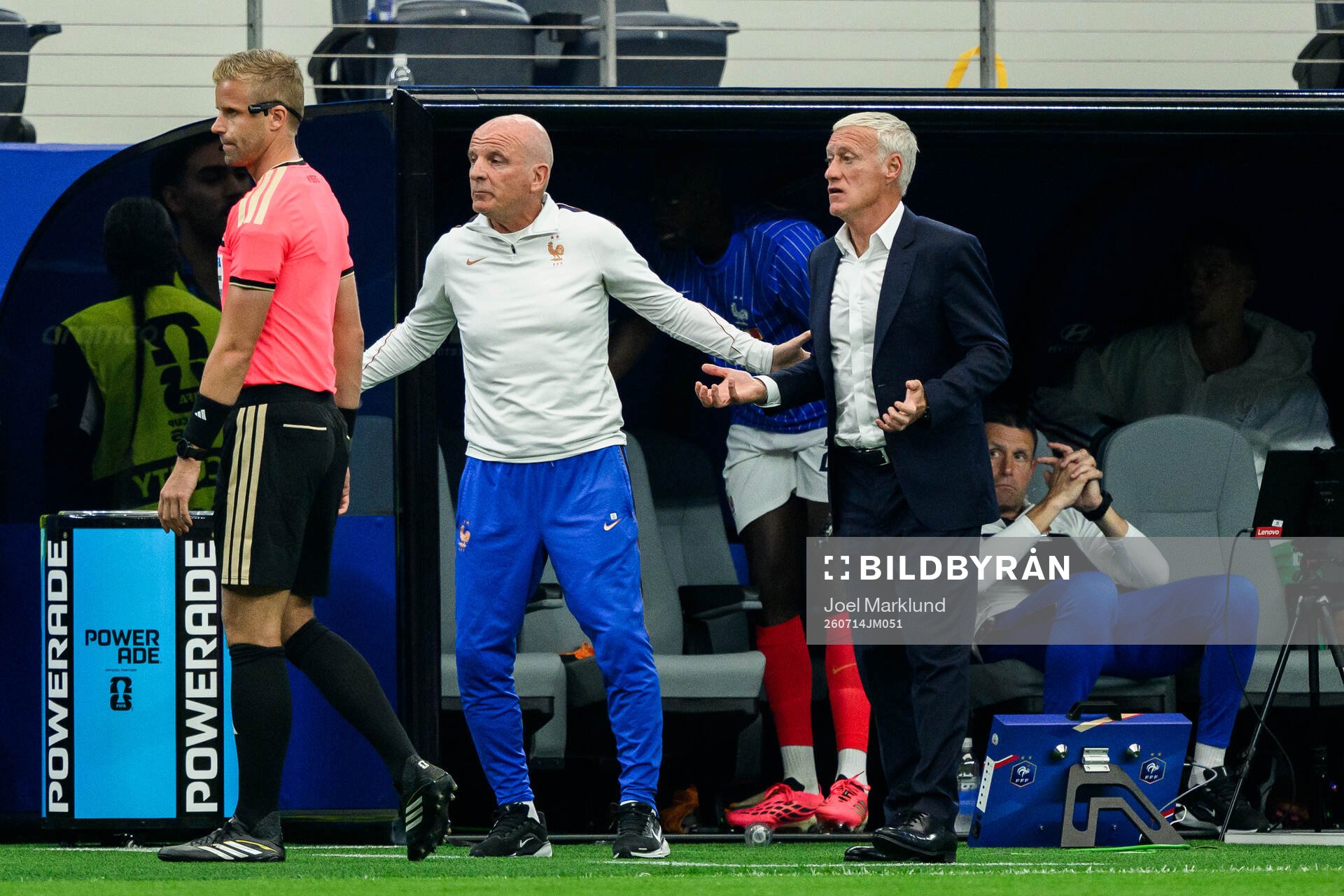 Assistant referee Glenn Nyberg and Head coach Didier Claude