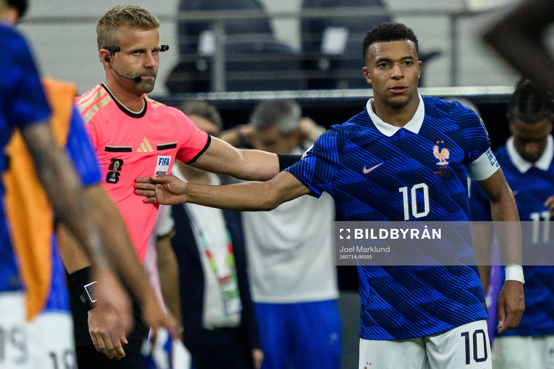 Assistant refere Glenn Nyberg and Kylian Mbappe of France