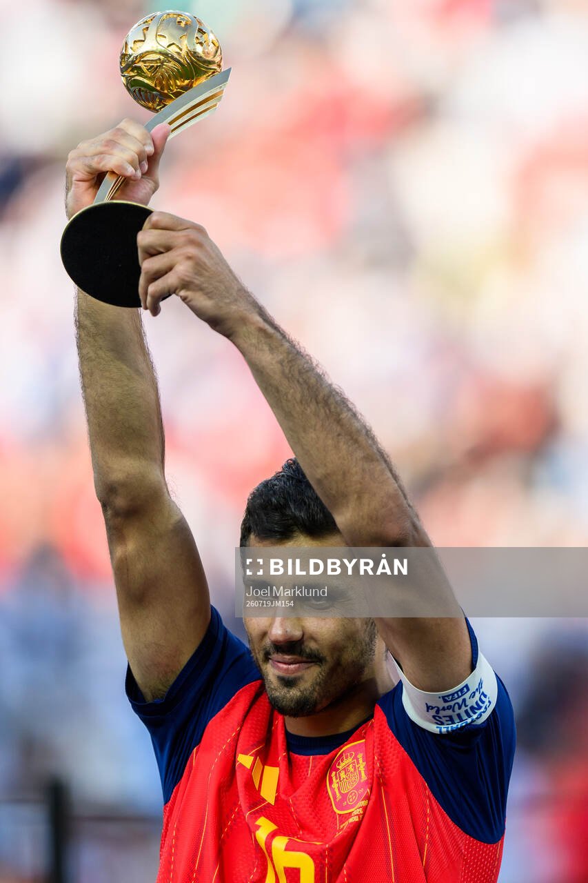 Rodri of Spain hoists his award for MVP of the tournament