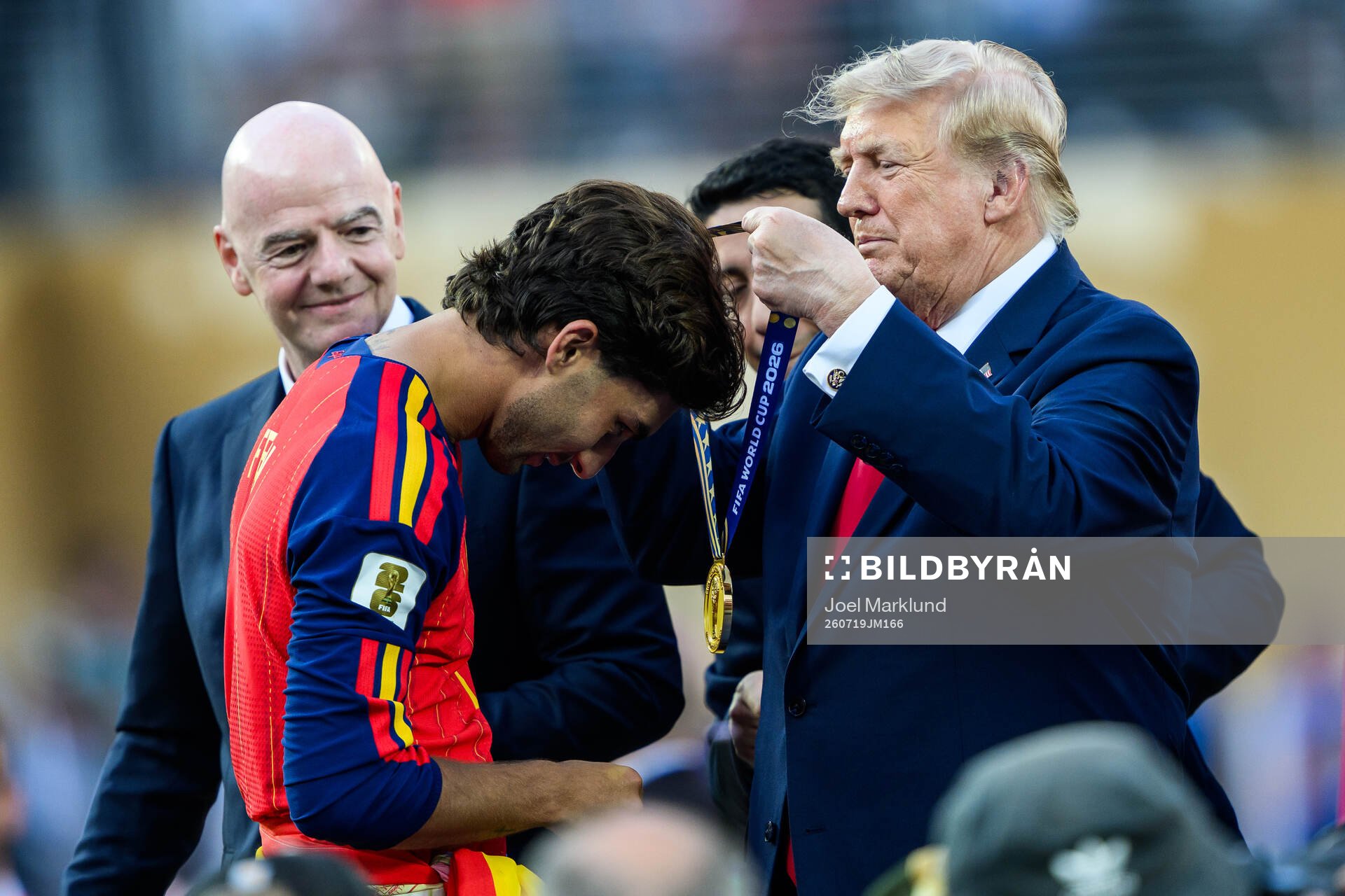 Ferran Torres of Spain is given a gold medal by Donald