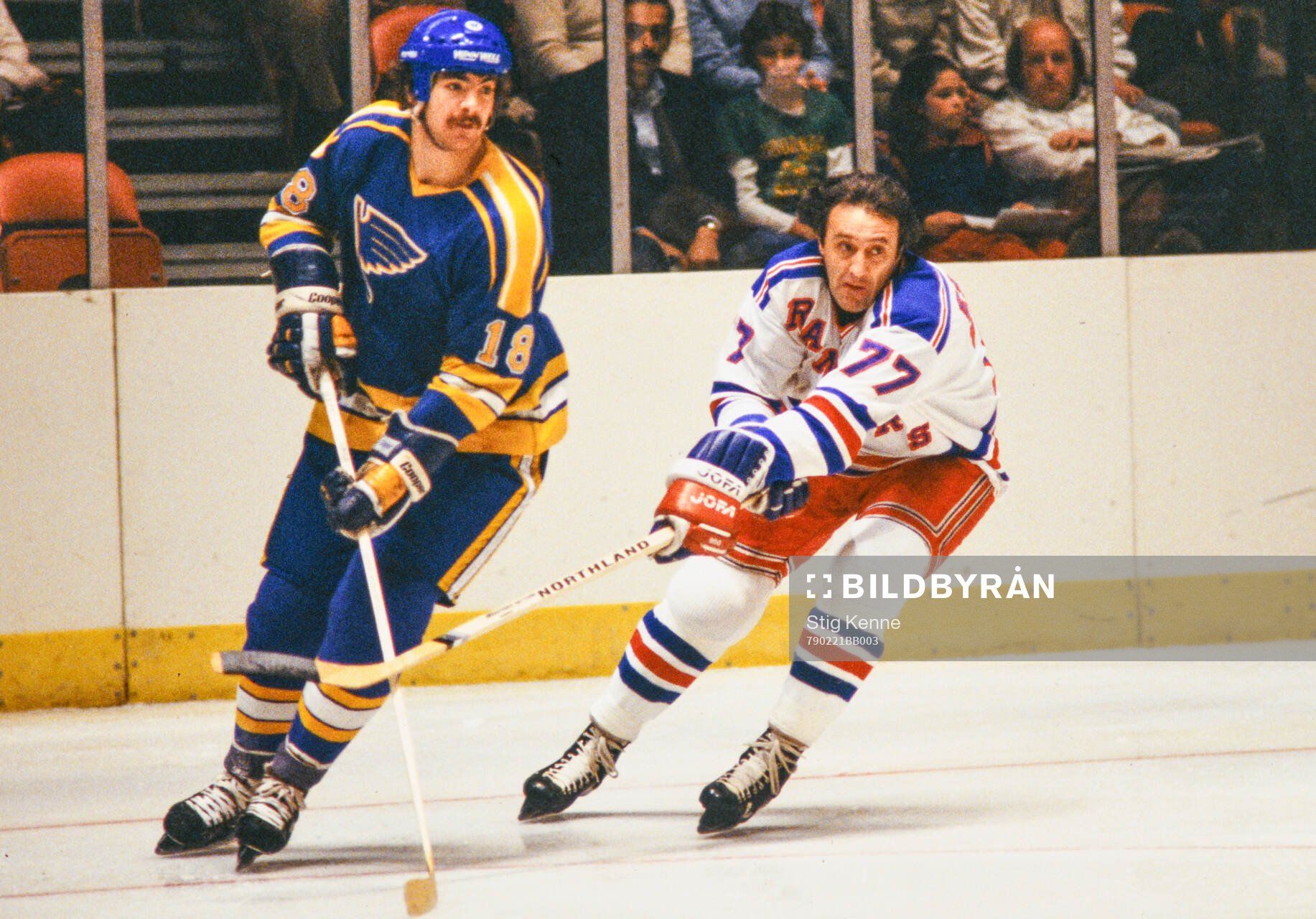 Phil Esposito of New York Rangers (R) against Harvey