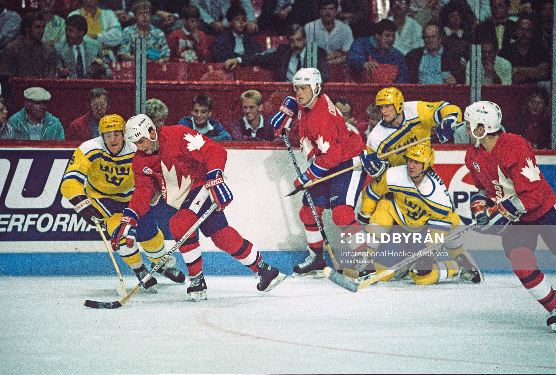 Brent Sutter carries the puck as Sweden's #19 Peter