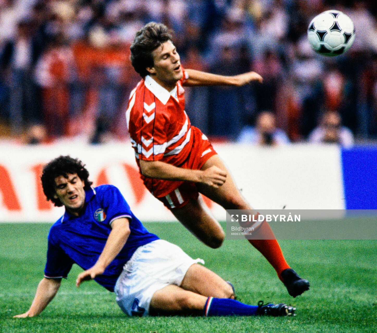 Denmarks Michael Laudrup is tackled by Italys Roberto