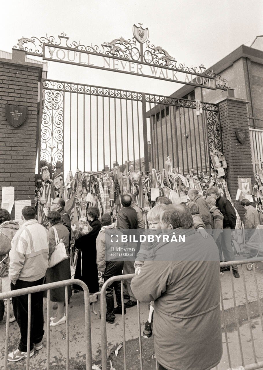 People pass outside Anfield to pay tribute to the 96