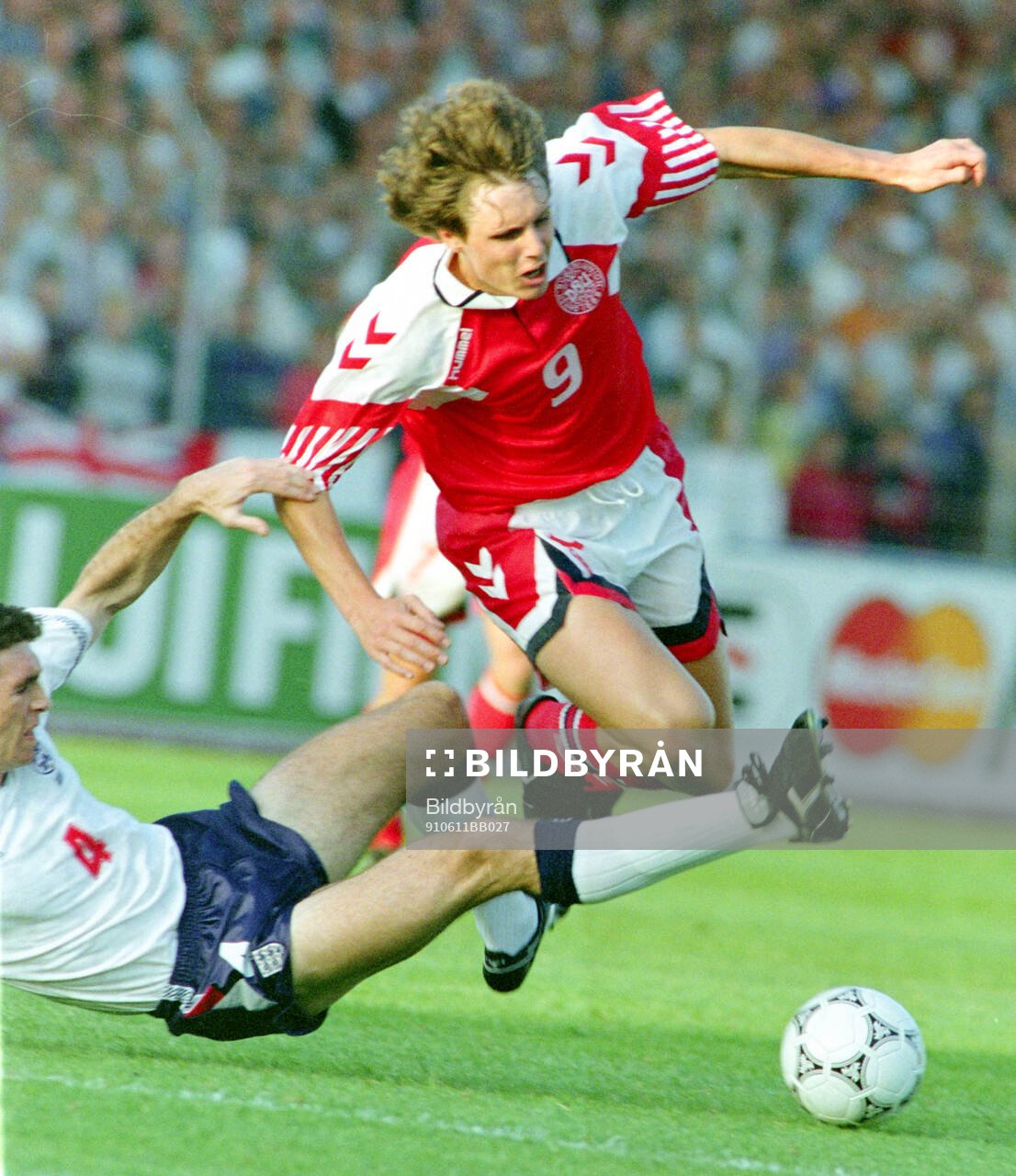 Denmarks Flemming Povlsen is tackled by Englands Martin