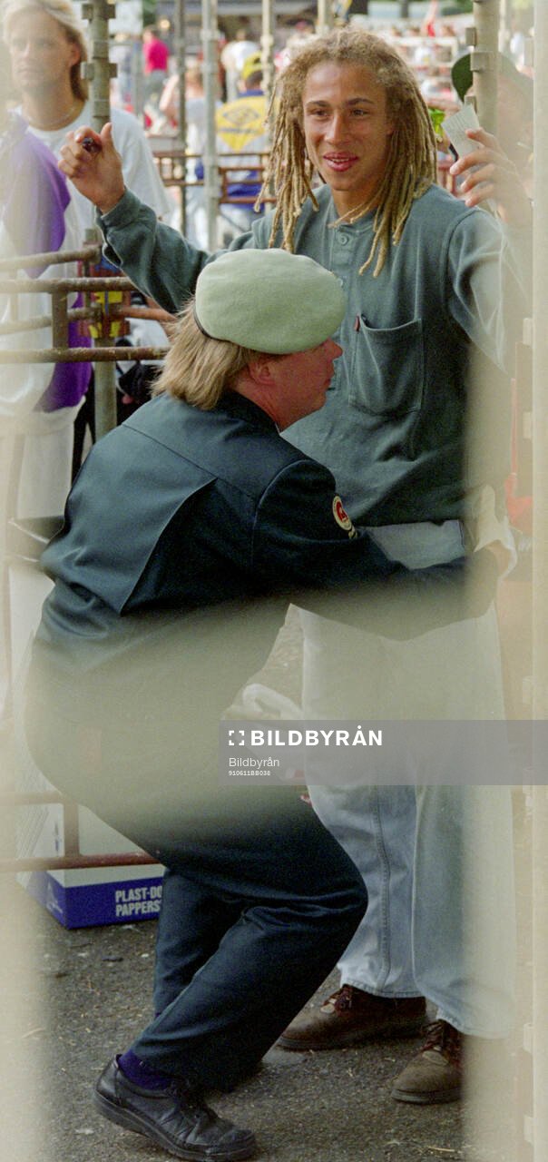 Swedish footballer Henrik Larsson is searched by a guard