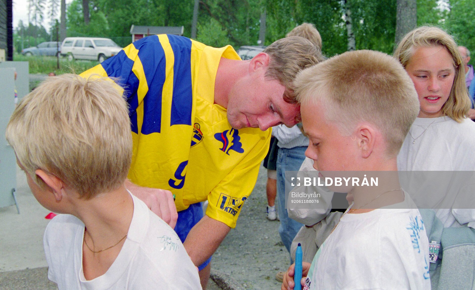 Swedens Jan Eriksson writes autographs to young fans at