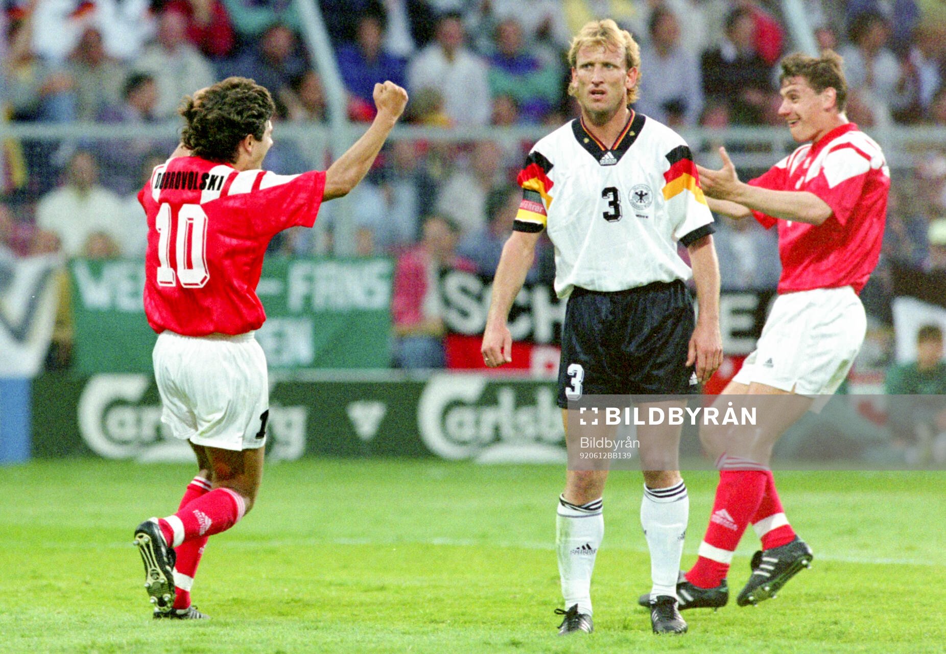Igor Dobrovolskiy of CIS (L) celebrates his 1-0 goal with