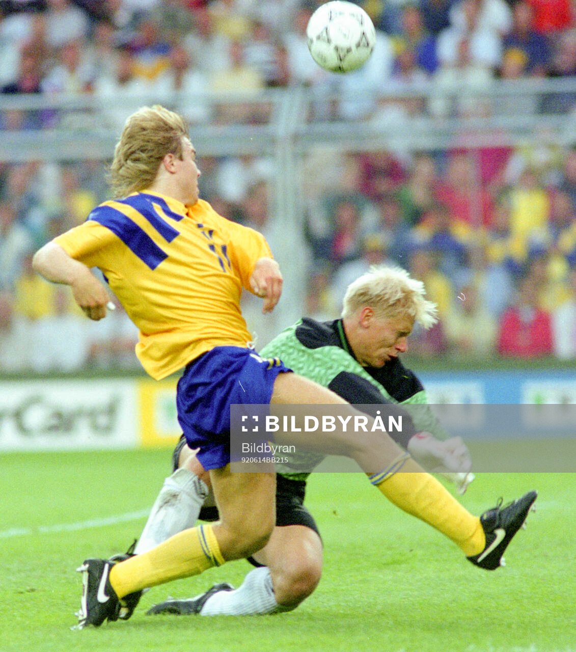 Swedens Tomas Brolin against Denmarks goalkeeper Peter