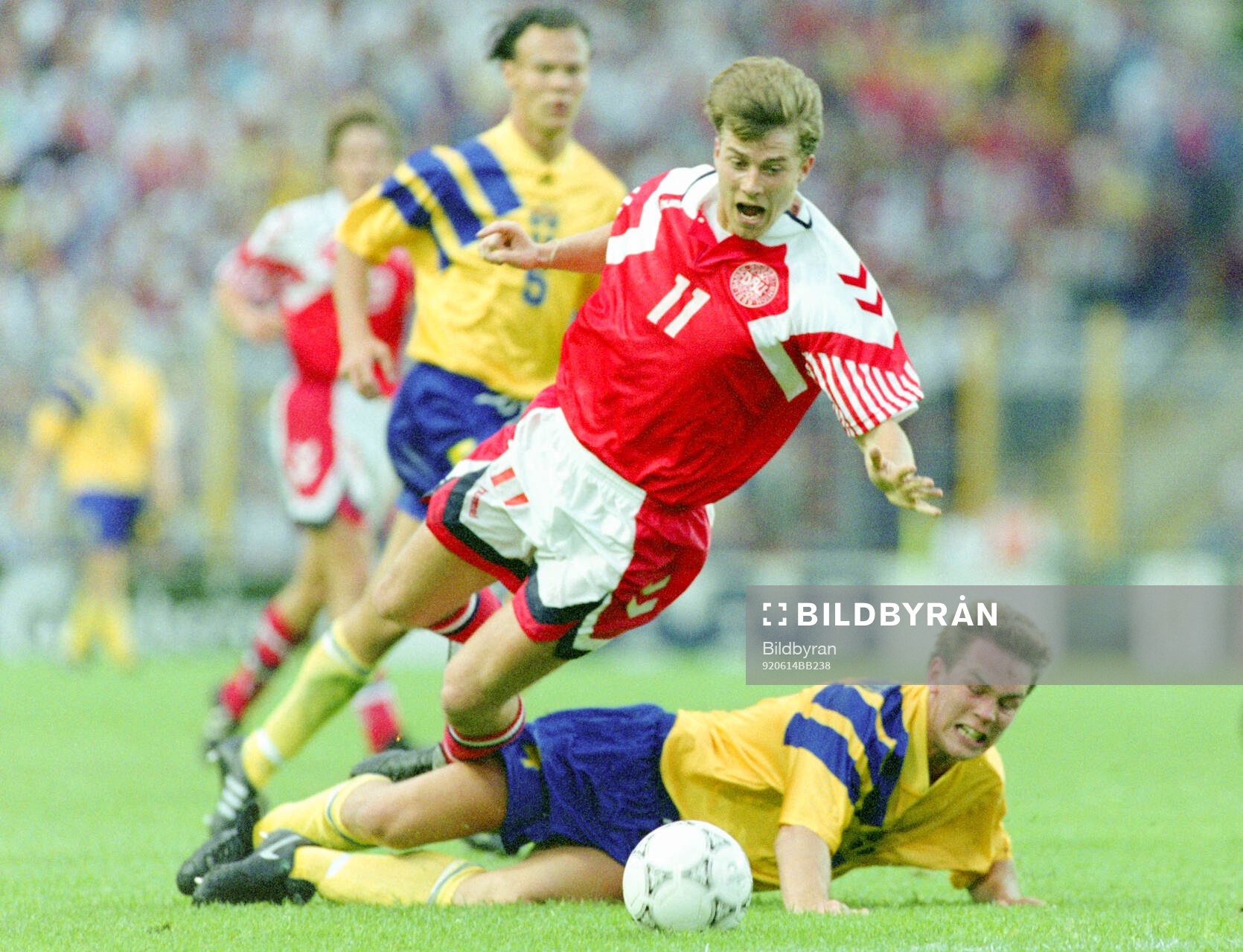 Denmarks Brian Laudrup is tackled by Swedens Patrik