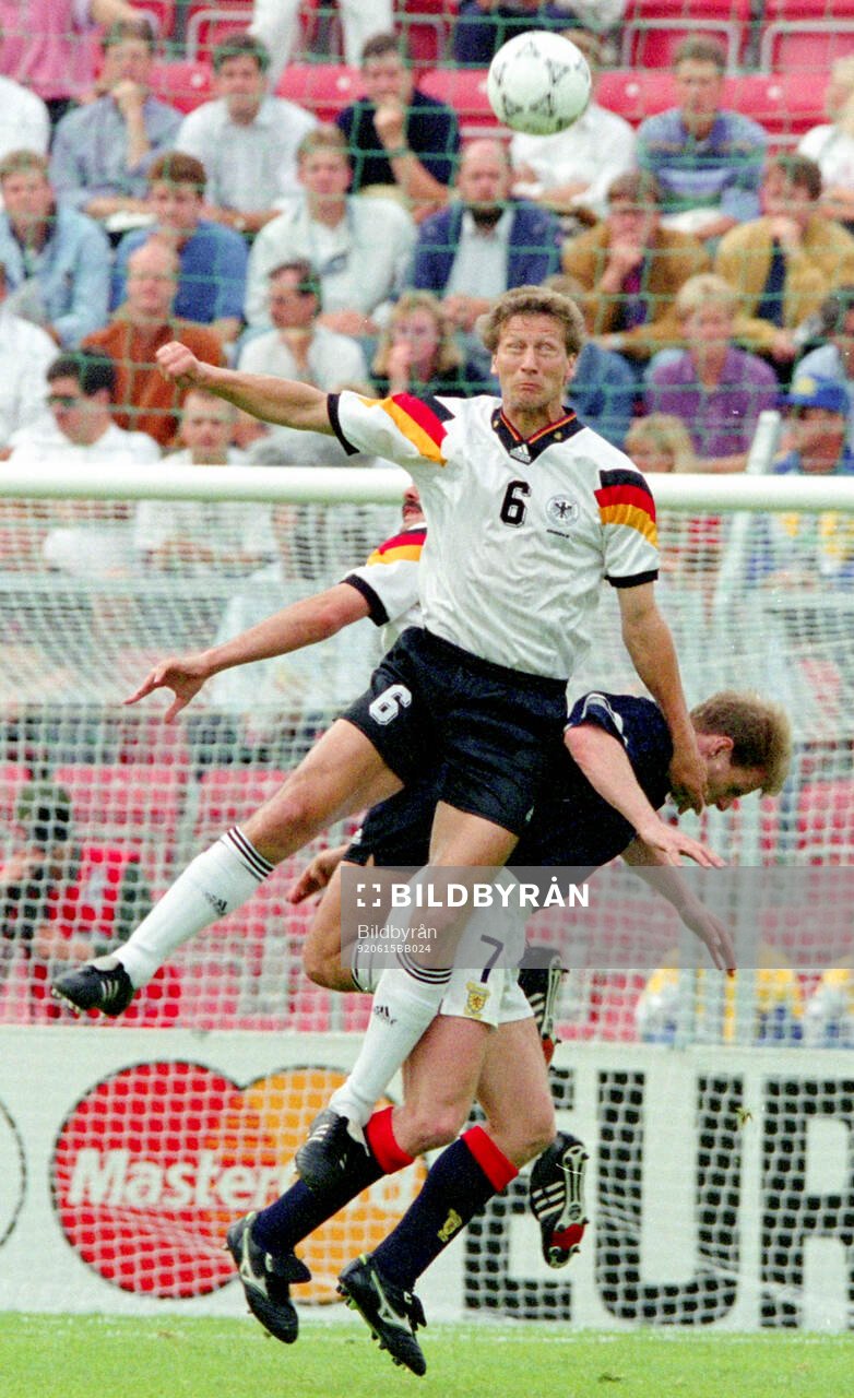 Germanys Guido Buchwald in aerial duel against Scotlands