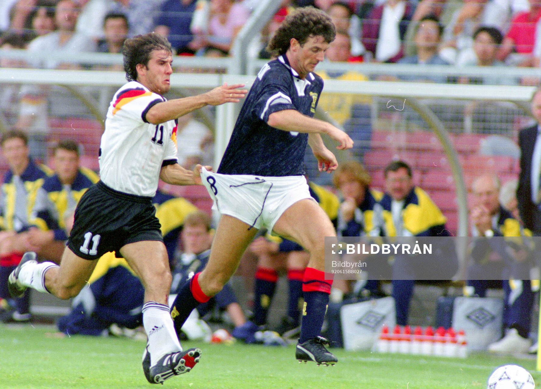 Germanys Karl-Heinz Riedle (L) against Scotlands Dave Mc