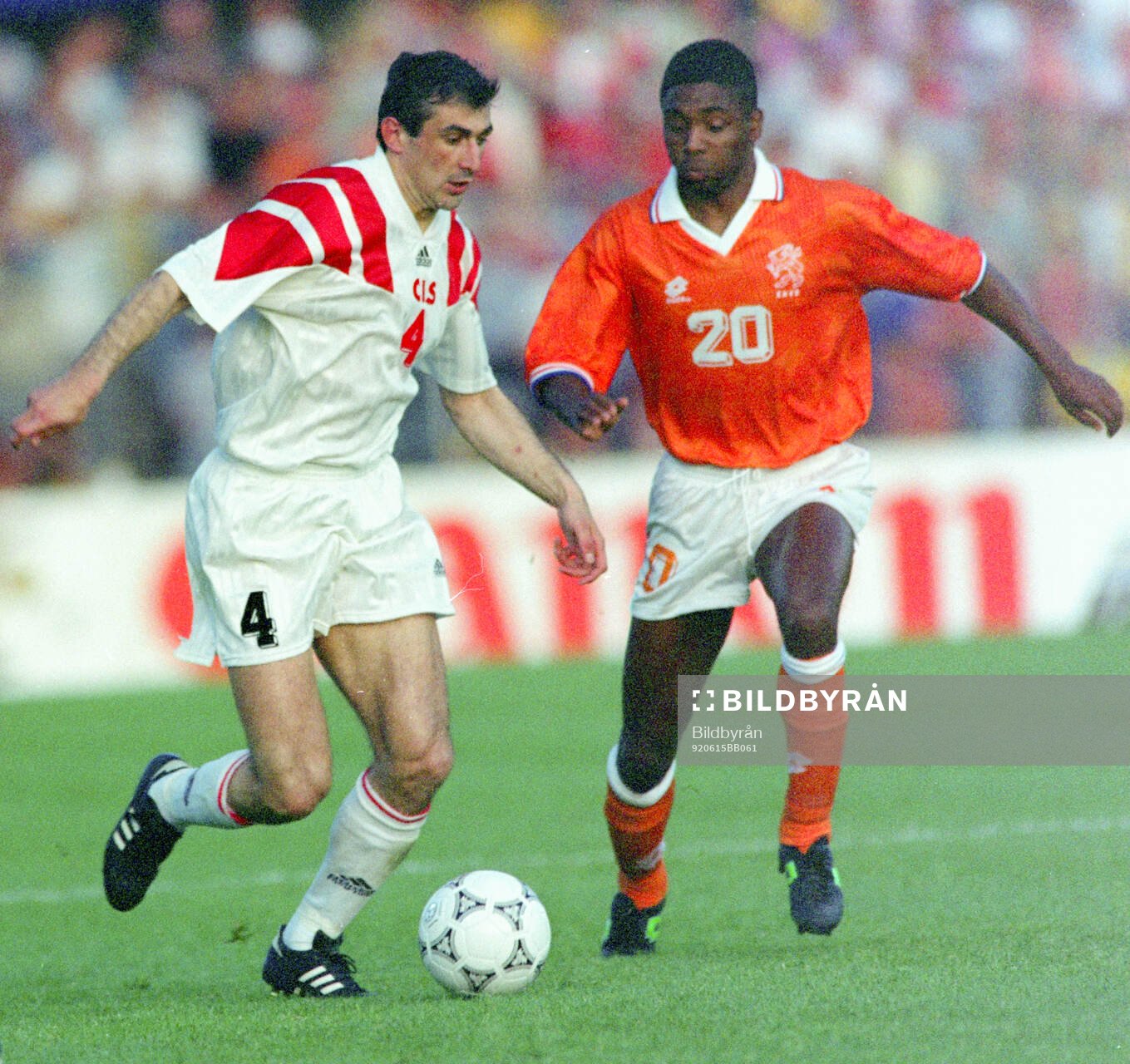 Ahkrik Tsveiba of CIS (L) against Netherlands Bryan Roy