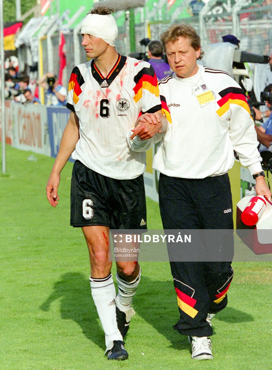 Germanys Guido Buchwald is helped off the pitch