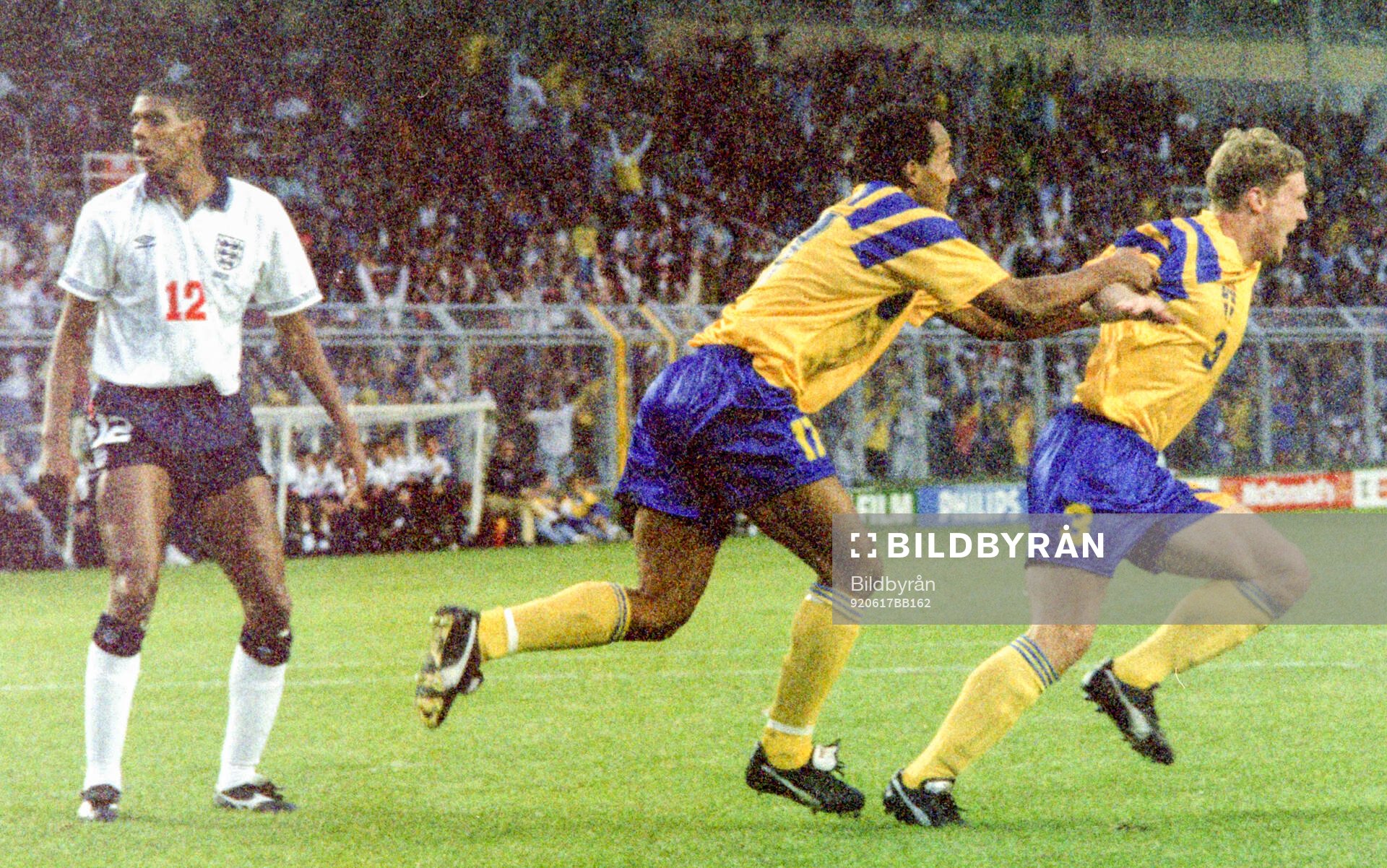 Swedens Jan Eriksson (R) celebrates his equalizing goal for