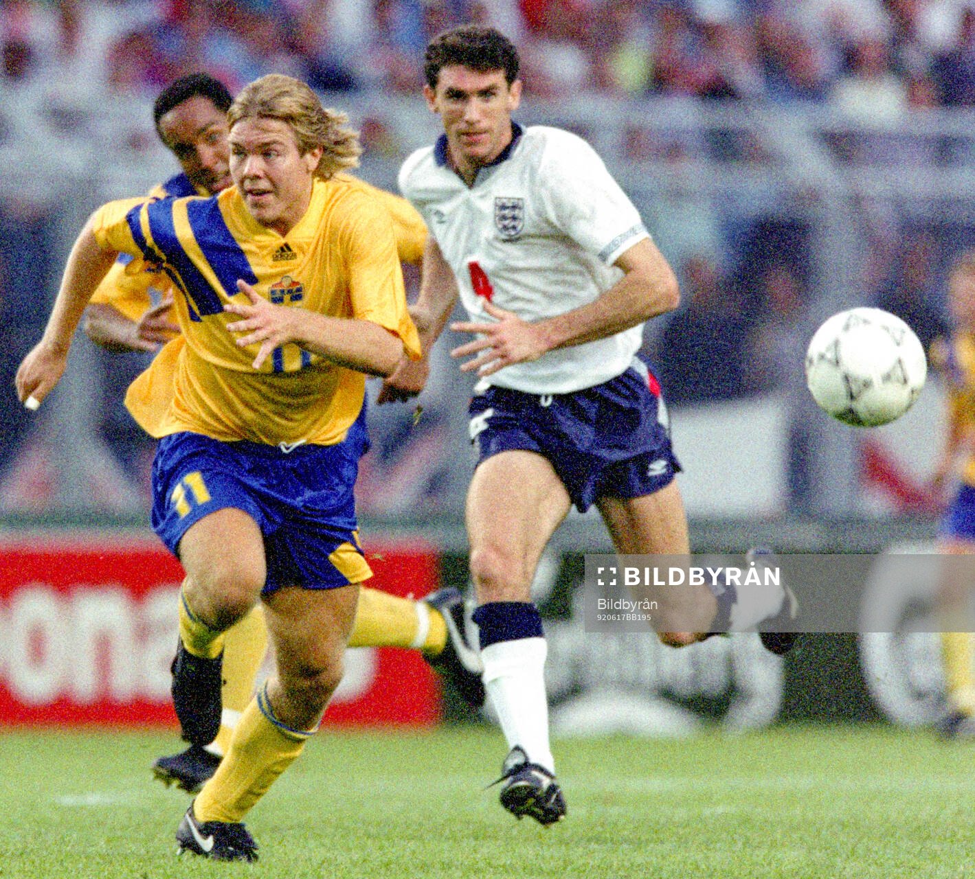 Swedens Tomas Brolin is chased by Englands Martin Keown