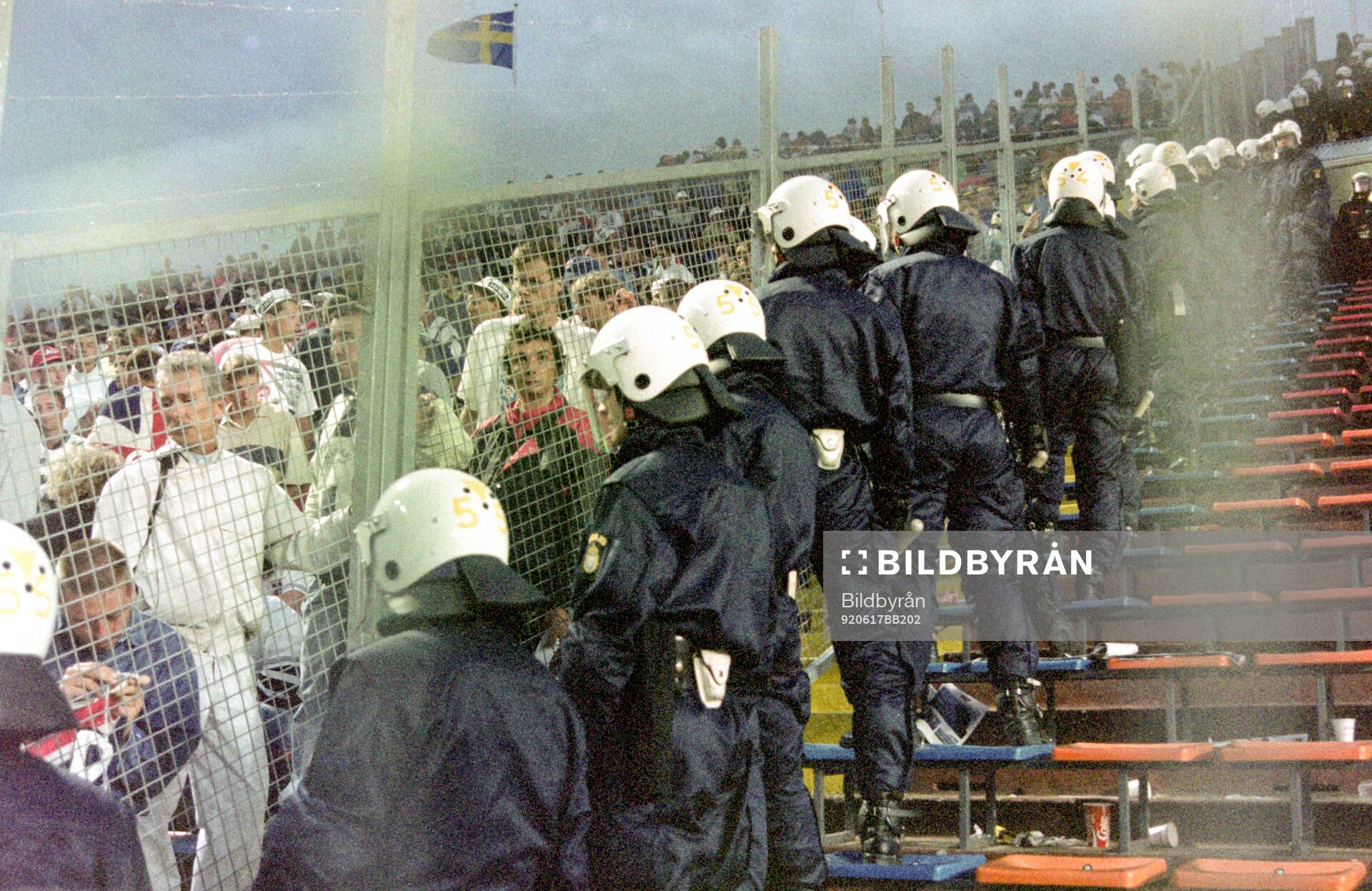 English fans in the stands at Rasunda Stadium are watched