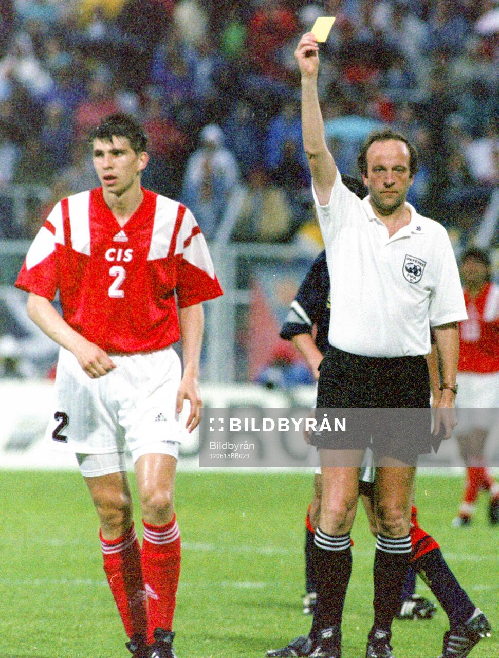 Referee Kurt Rothlisberger shows Andrey Chernyshov of CIS a