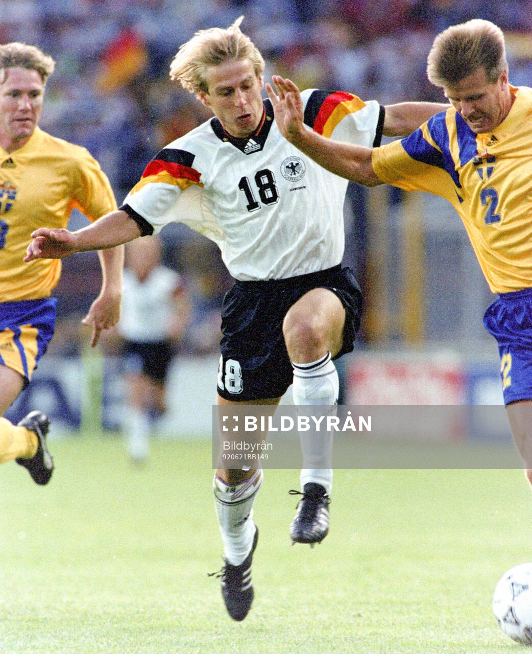 Jurgen Klinsmann of Germany against Jan Eriksson (L) and
