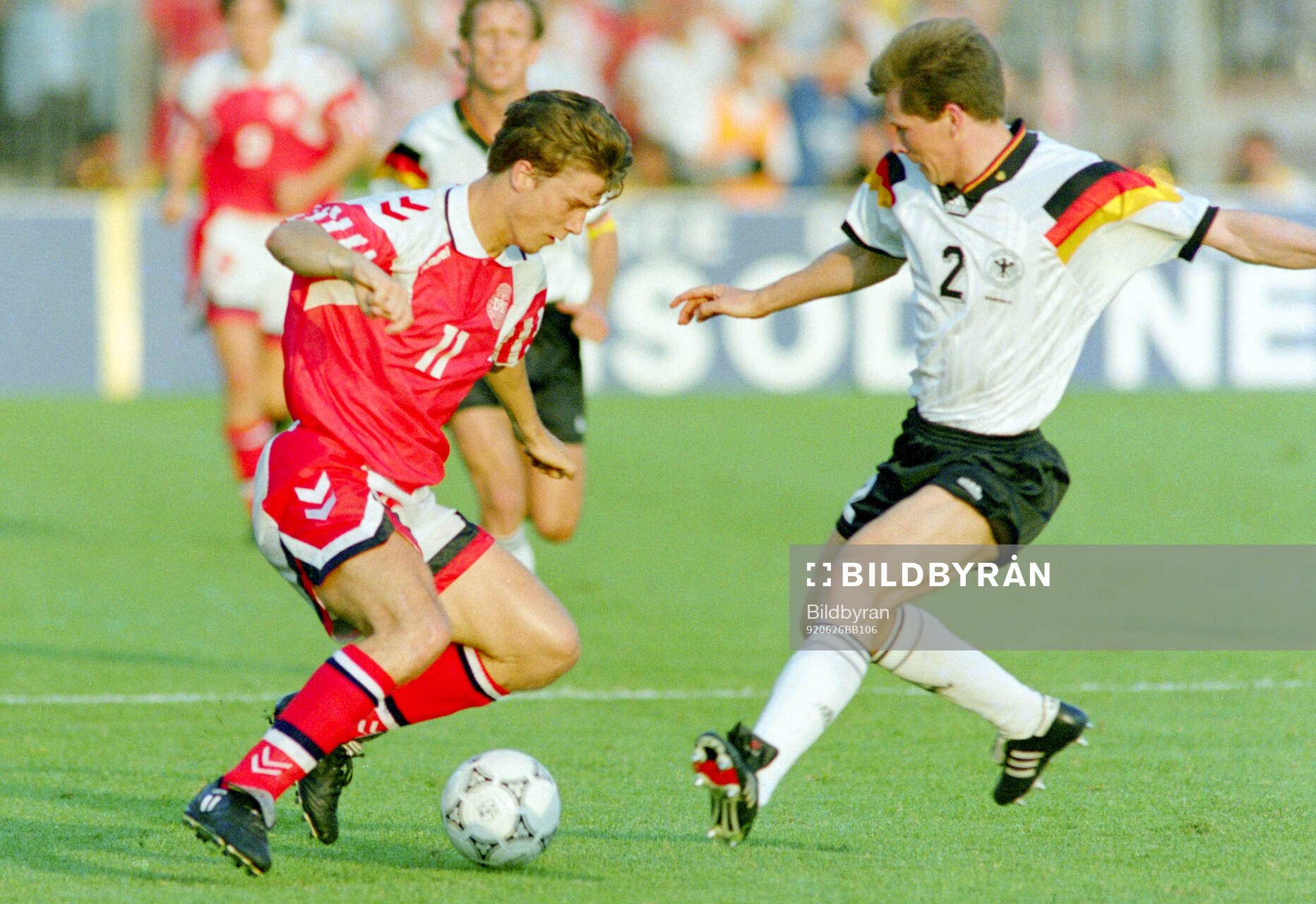Denmarks Brian Laudrup (L) against Germanys Stefan Reuter