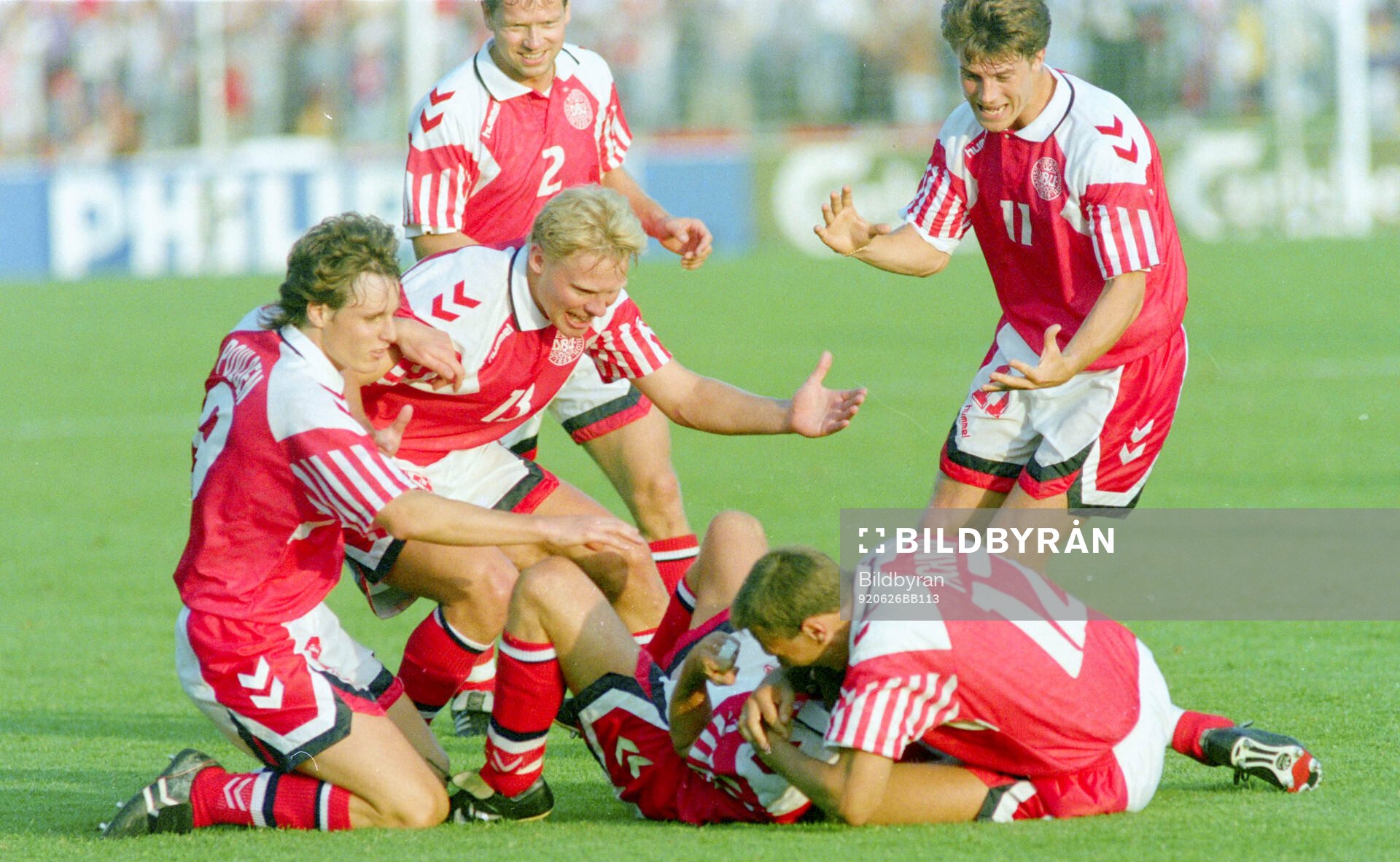 Denmarks John Jensen is mobbed by team mates
