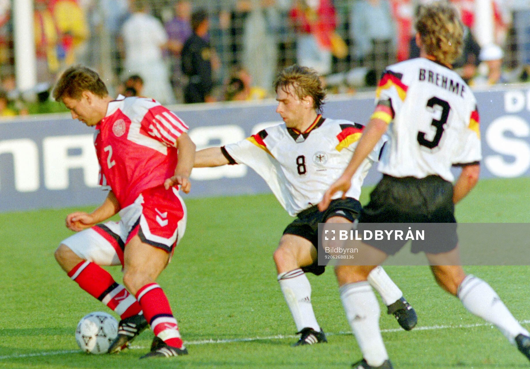 Denmarks John Sivebaek against Germanys Thomas Hassler and