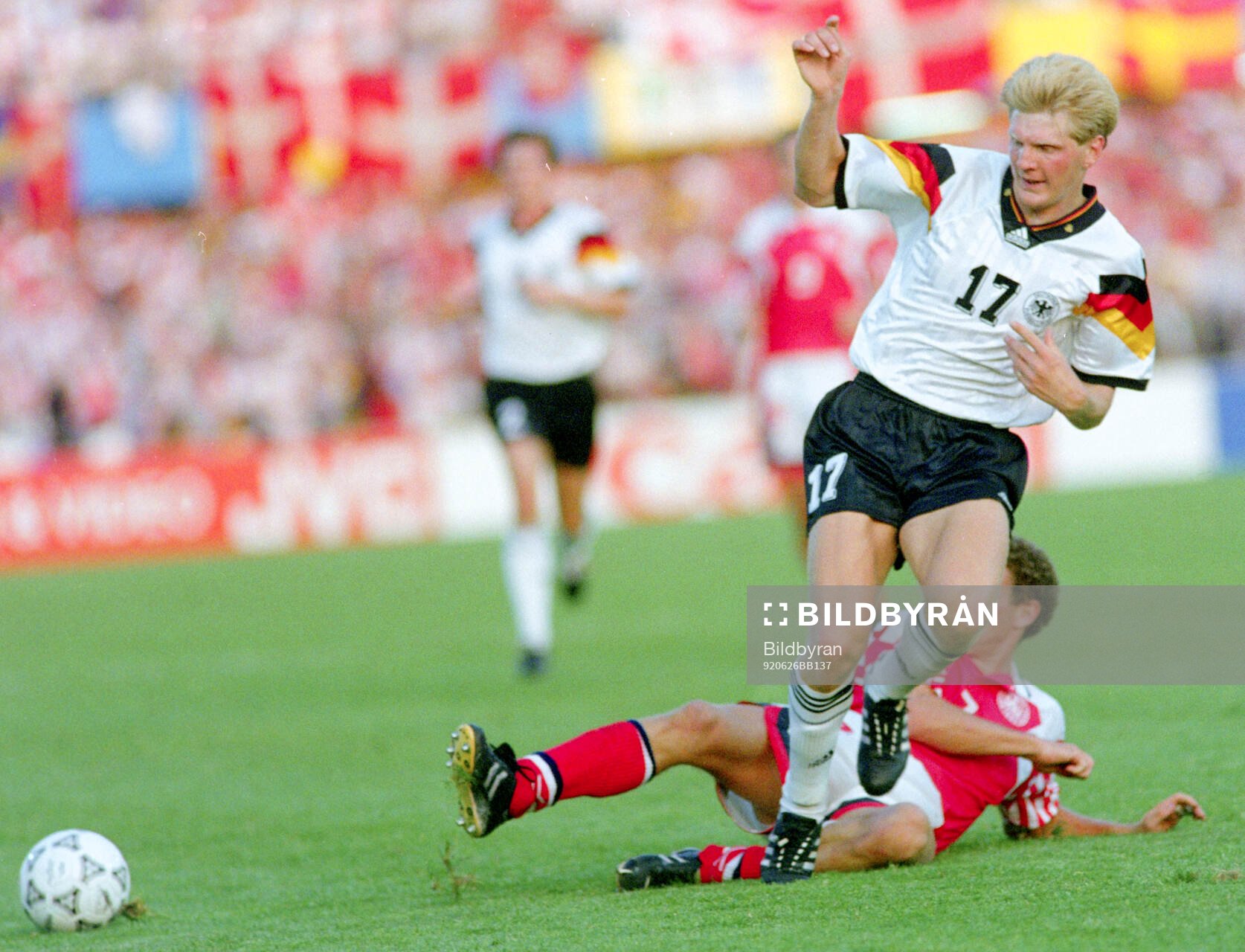 Germanys Stefan Effenberg is tackled by Denmarks John Jensen