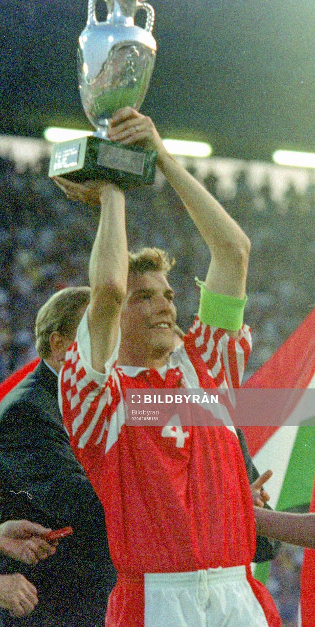 Denmarks captain Lars Olsen celebrates with the trophy