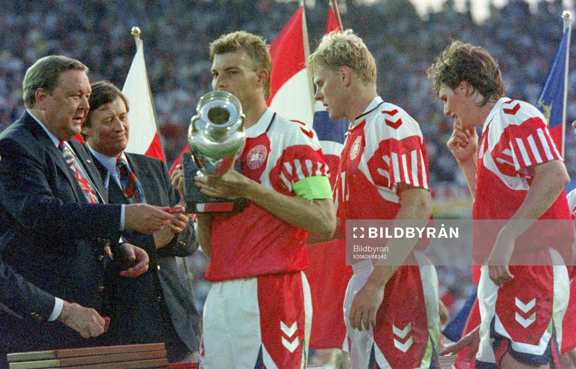 Denmarks captain Lars Olsen receives the trophy from UEFA