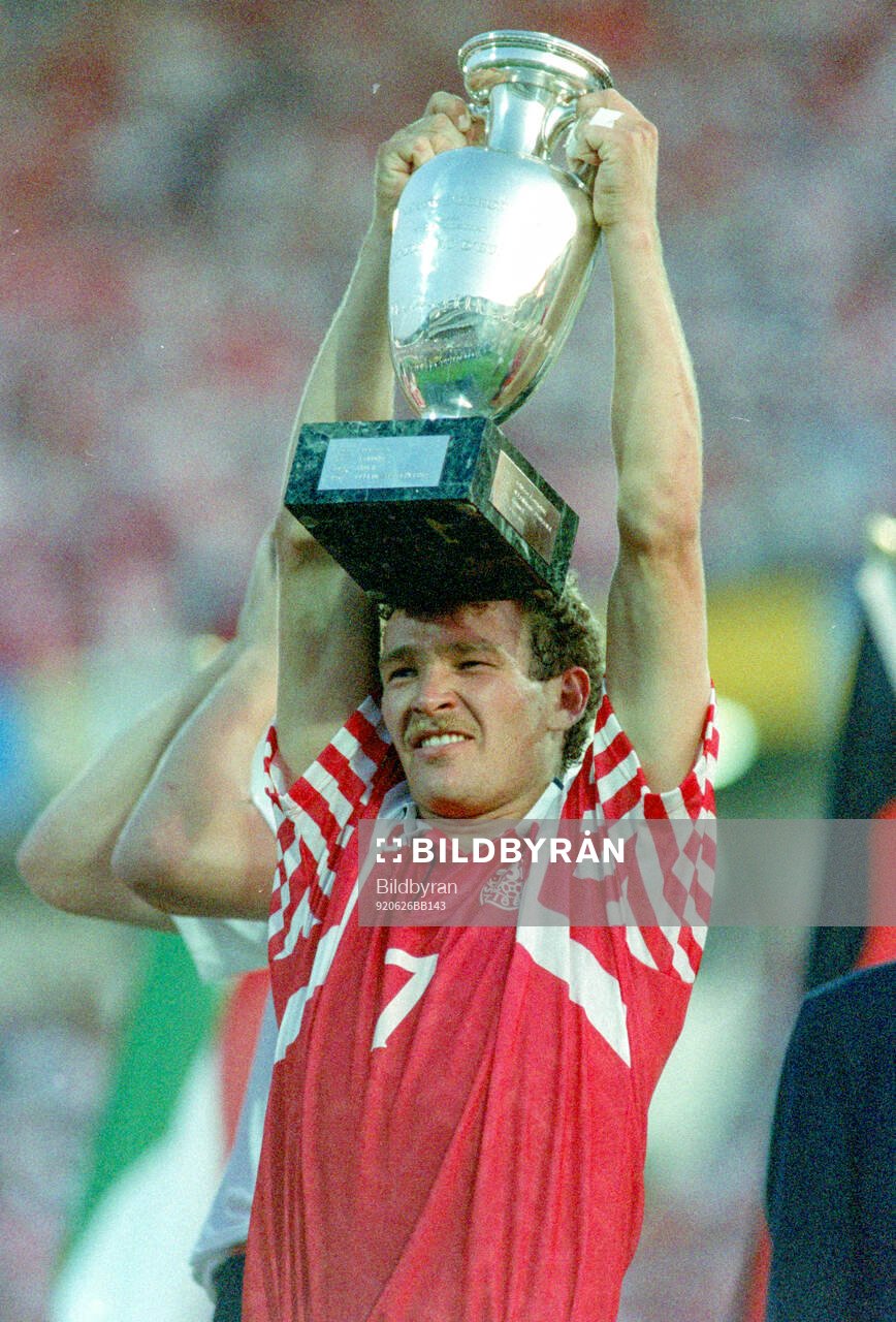 Denmarks John Jensen celebrates with the trophy