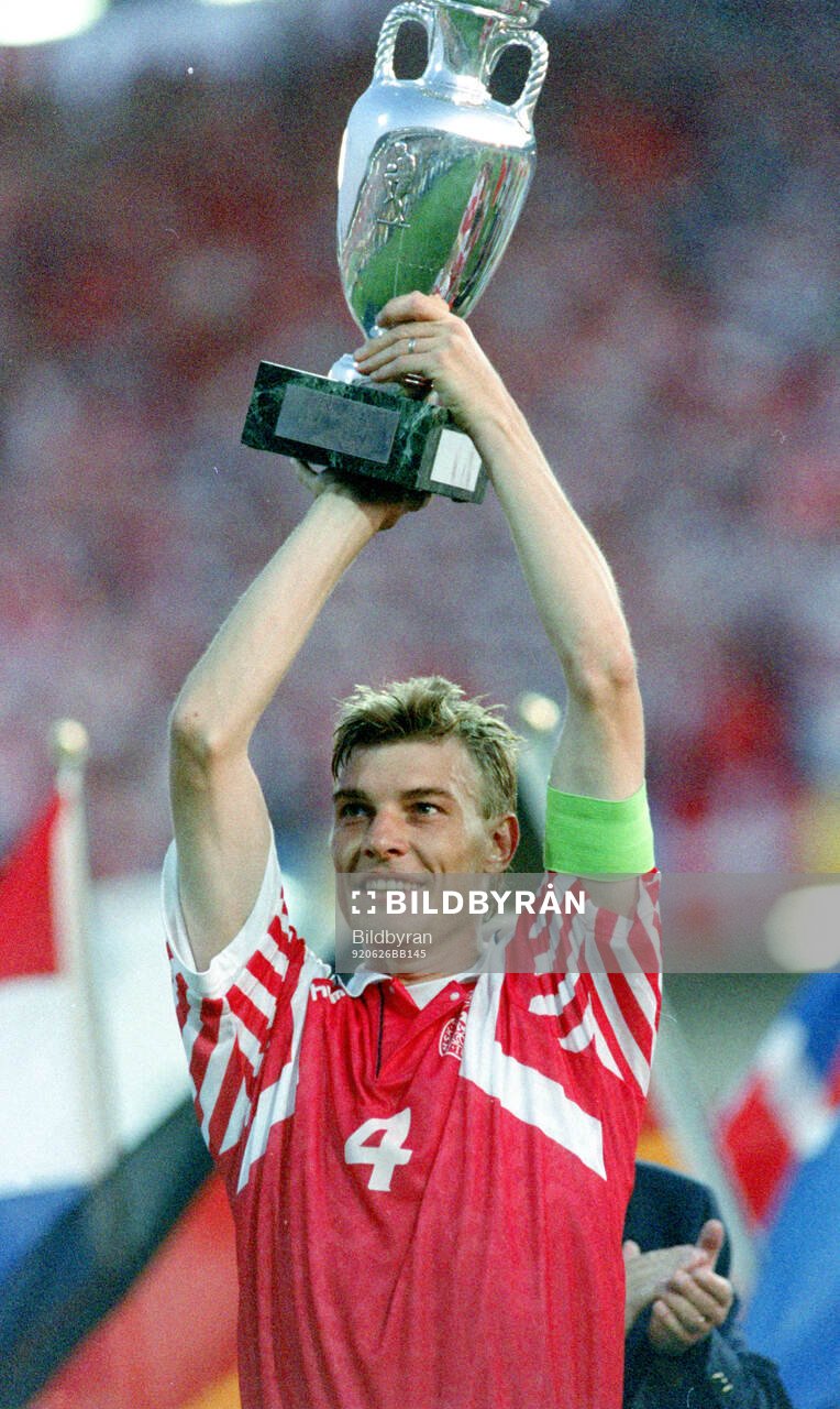Denmarks captain Lars Olsen celebrates with the trophy