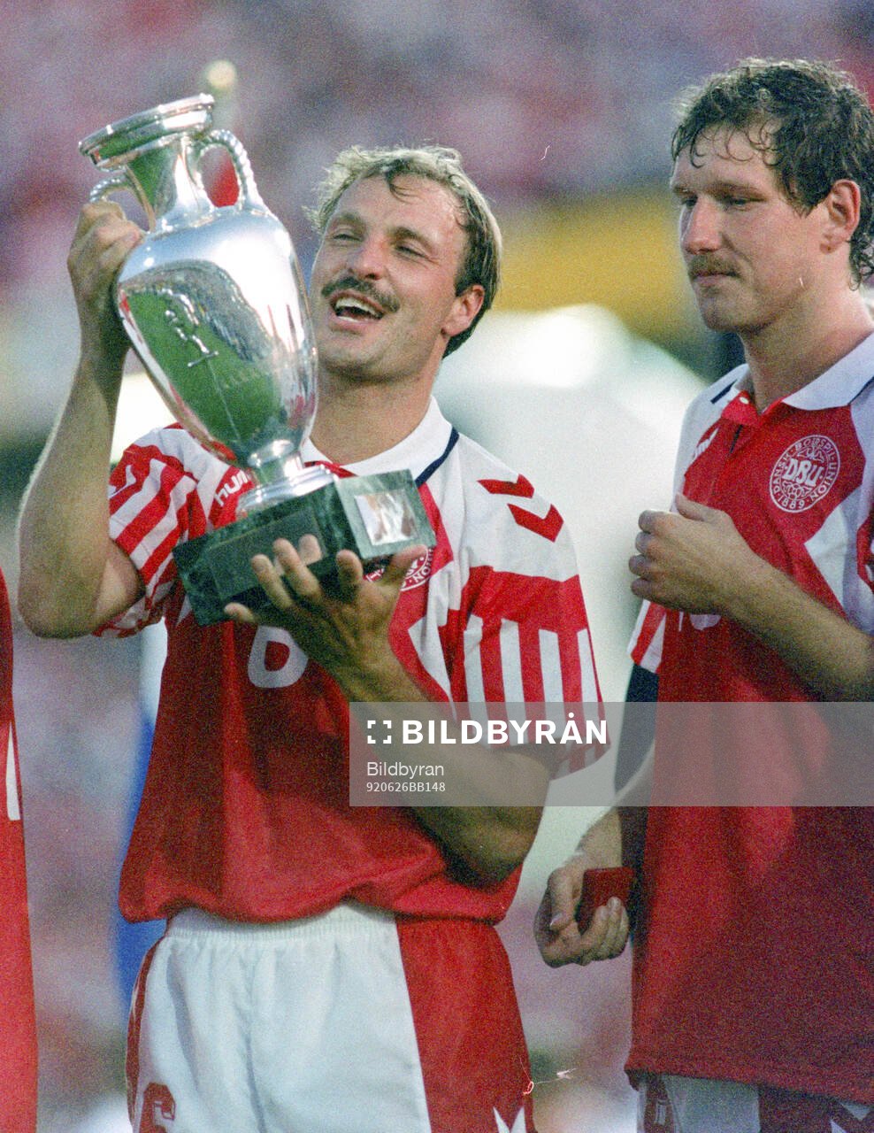 Denmarks BKim Christofte celebrates with the trophy