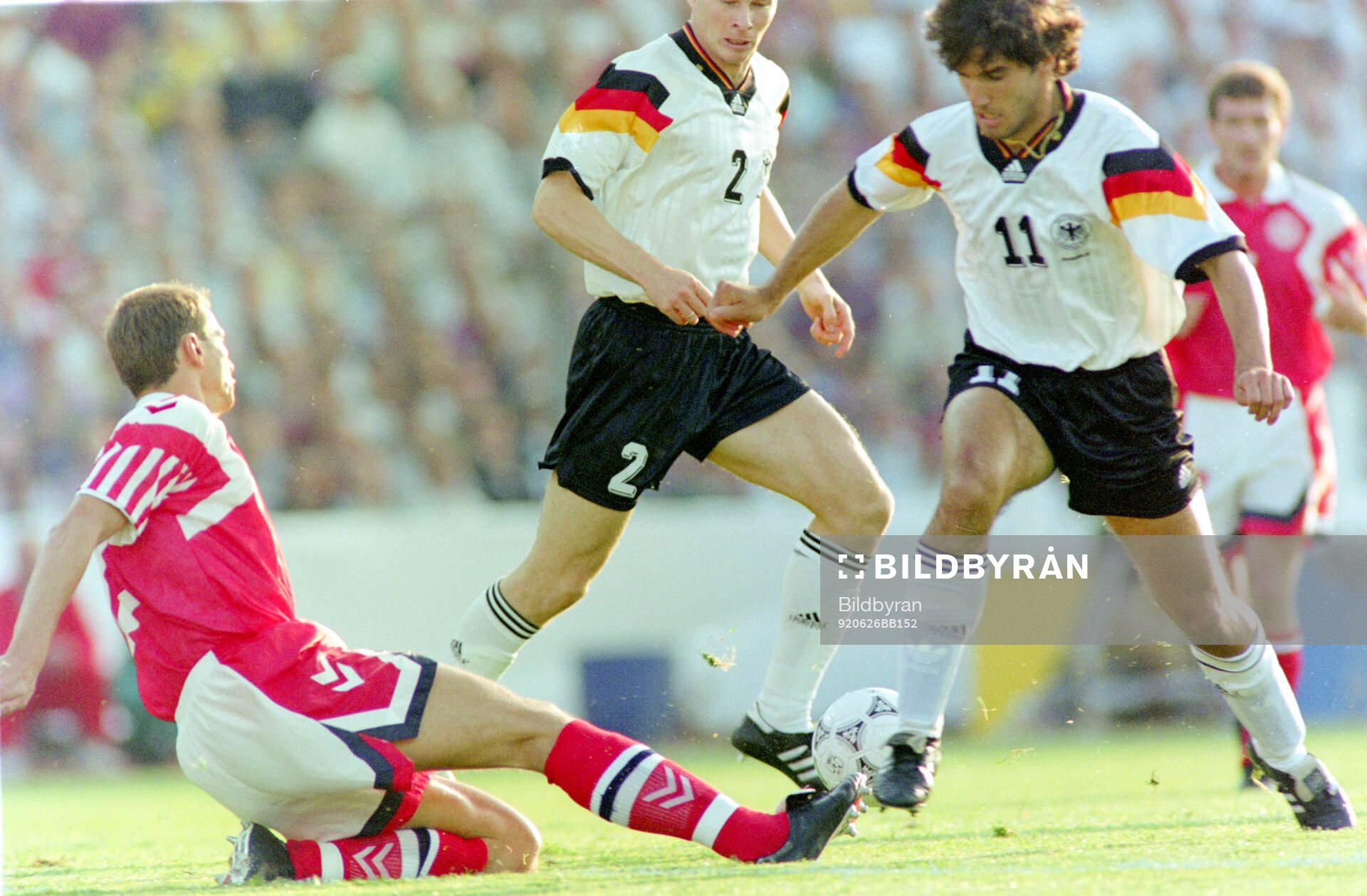 Germanys Karl-Heinz Riedle (R) against Denmarks Torben