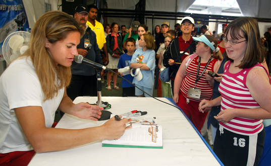 Amelie Mauresmo signs autographs for young admirers in