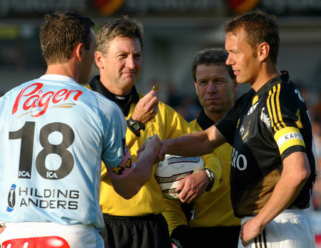 Krister Nordin och Patrik Andersson singlar slant. Domare