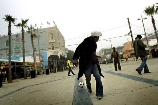 Reportage om fotboll i USA. Gatufotboll pÂ ett torg i Venice beach.
