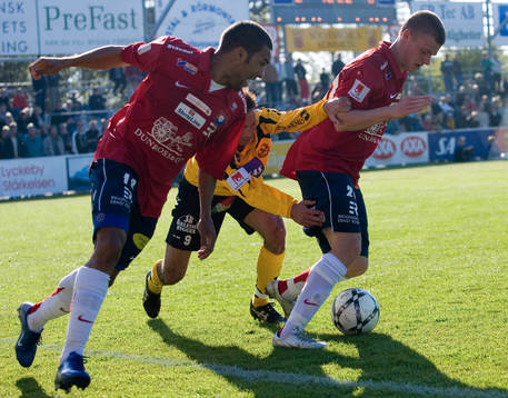 Två Örgryte-spelare  försöker stoppa  Marcelo Sarvas