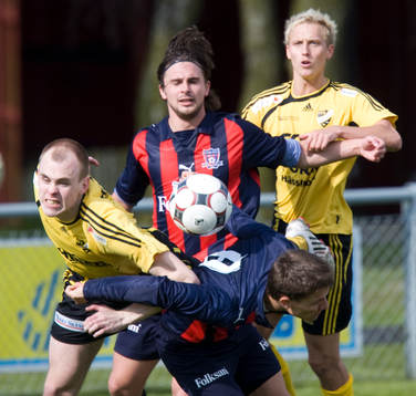  Johan Isgren böjer sig ner och bakom Robin Staaf och de båda Ramlösa-spelarna kämpar mot Hässleholms Fredrik Hägglund och Bobby Alm Nilsson.