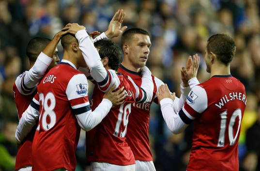  Football - Reading v Arsenal - Barclays Premier League  - The Madejski Stadium - 17/12/12 Lukas Podolski celebrates scoring Arsenal's first goal with Jack Wilshere (R) and team mates