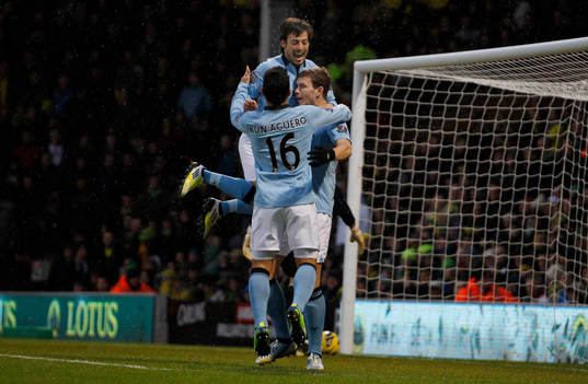  Football - Norwich City v Manchester City - Barclays Premier League  - Carrow Road - 29/12/12 Edin Dzeko celebrates scoring Manchester City's first goal with David Silva (top) and Sergio Aguero 