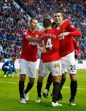  Football - Wigan Athletic v Manchester United - Barclays Premier League - DW Stadium - 1/1/13 Robin van Persie celebrates scoring the second goal for Manchester United with Ryan Giggs (L) and Javier Hernandez (C)
