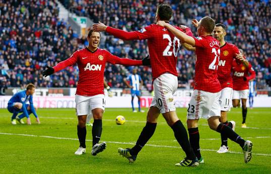  Football - Wigan Athletic v Manchester United - Barclays Premier League - DW Stadium - 1/1/13 Robin van Persie celebrates scoring the second goal for Manchester United with Javier Hernandez (L) and team mates