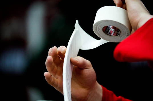 en kille tejpar klubban