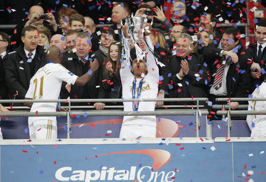 l - Bradford City v Swansea City - Capital One Cup Final - Wembley Stadium - 24/2/13 Swansea City's Wayne Routledge celebrates with the Capital One Cup 