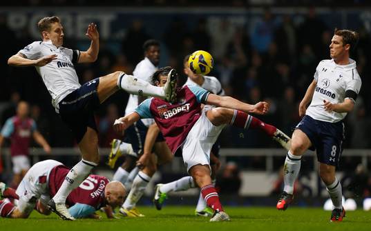  Football - West Ham United v Tottenham Hotspur - Barclays Premier League  - Upton Park - 25/2/13 West Ham's Andy Carroll (C) in action with Tottenham Hotspur's Michael Dawson and Scott Parker (R)