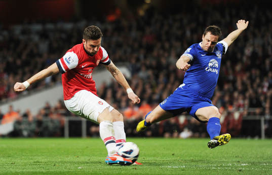  Football - Arsenal v Everton - Barclays Premier League  - Emirates Stadium - 16/4/13 Arsenal's Olivier Giroud (L) shoots at goal past Everton's Phil Jagielka