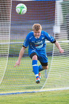 Osbys Jacob Lang räddar på mållinjen i matchen i division 3 mellan IFK Osby och IFK Hässleholm i Osby 15 maj  2014.